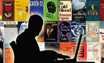 An author is typing over a background of famous novel covers