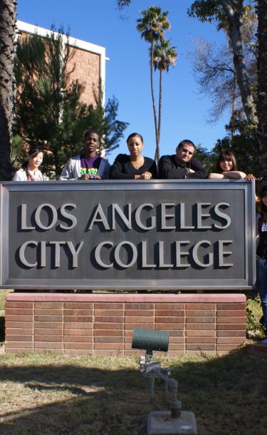 Students Standing Next to the LACC Sign 