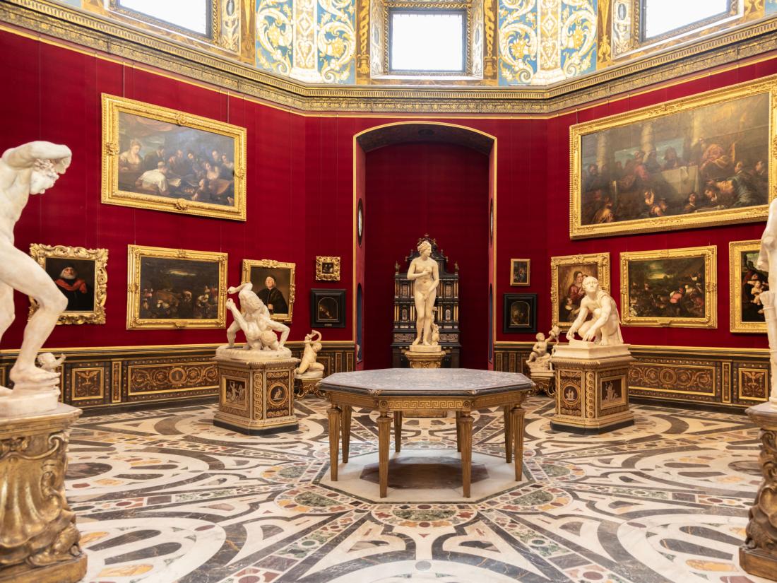 Museum room with sculptures and paintings