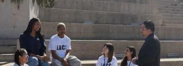 chancellor and students on stairs